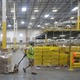 An employee pulls a cart with packages at the Amazon Fulfillment center in Robbinsville Township, N.J., Tuesday, Aug. 1, 2017.